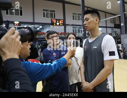 American professional basketball player Jeremy Lin of the Beijing Ducks is interviewed after a preseason game against Jilin Northeast Tigers in Beijin Stock Photo