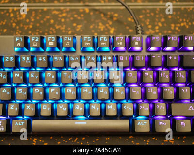 multi-colored keyboard. mechanical keys. Multi-colored professional gaming mechanical rgb keyboard on the table background  Stock Photo