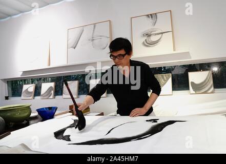 (191012) -- SHANGHAI, Oct. 12, 2019 (Xinhua) -- Wang Xuyuan, chief director of Han Shu Art Center in Shanghai Normal University, creates at the art center in east China's Shanghai, Oct. 11, 2019. Wang Xuyuan's works featuring various art forms including Chinese ink painting skills combine the beauty of polar landscape with a concept of the spirit of human exploration. (Xinhua/Zhang Jiansong) Stock Photo