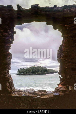 Devil'S Island, French Guiana. 11th Oct, 2019. Through ruins a view of the rocky islet of Devils Island (Isle du Diable) from Isle Royale, one of the three islands (Royale, Saint-Joseph, and Diable) of the volcanic Isles du Salut group off French Guiana, collectively called Devils Island (Isle du Diable). Now a nature reserve, serving tourists and cruise ship passengers, visitors are not allowed on small Devils Island but tour the decaying old prison facilities on nearby Isle Royale. Credit: Arnold Drapkin/ZUMA Wire/Alamy Live News Stock Photo