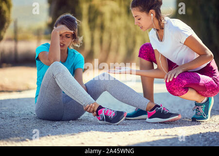 Running sport fitness. Young woman injury at jogging.