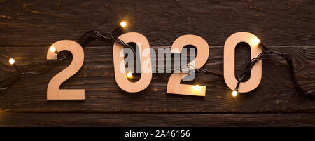 Close up of 2020 wooden numbers with new year garland Stock Photo