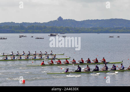 Four rowing teams compete against each other at the West-lake during the 2019 World Famous Campus Sports Series - Hangzhou West-lake Rowing Race in Ha Stock Photo