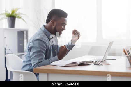 African American Businessman Celebrating Victory At Work Stock Photo