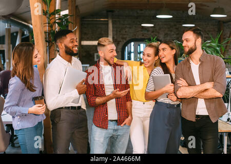 Successful workers having break, talking and laughing Stock Photo