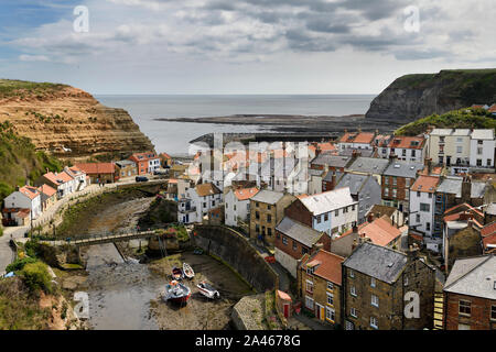 Overview of seaside village of Straithes where Straithes Beck empties into the  Harbour on the North Sea at low tide North Yorkshire England Stock Photo