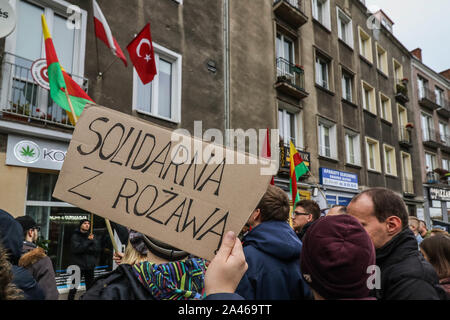 Gdansk, Poland. 12th, October 2019 Protesters with Kurdish flag (Flag of the PYD for Rojava) holding banner which says ' Solidarity with Rojava '  in front of Turkish Consulate are seen in Gdansk, Poland on 12 October 2019  People protest against Turkey's military invasion in Syria.  © Vadim Pacajev / Alamy Live News Stock Photo