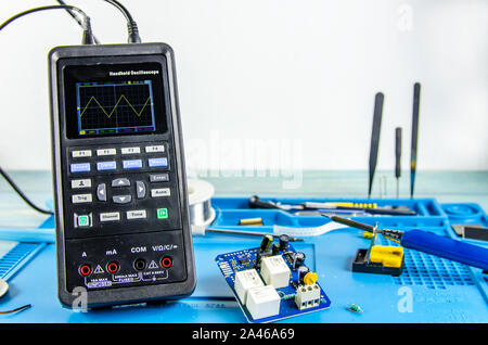 The electrician's workplace. Electronics. Schemes soldering iron. oscilloscope Stock Photo