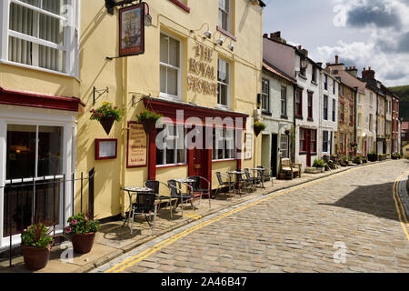 The Royal George hotel restaurant on cobblestone High Street in the seaside village of Staithes North Yorkshire England Stock Photo