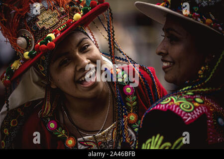 Barcelona, Spain. 12 October, 2019:  Young Bolivian women in her traditional costumes dance as she parade through Barcelona to celebrate the Columbus Day Credit: Matthias Oesterle/Alamy Live News Stock Photo