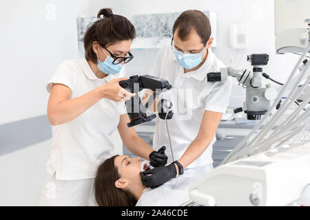 Professional dentist taking photo of patient teeth Stock Photo