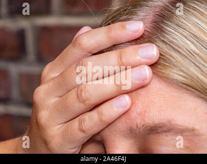 young Woman has a headache Stock Photo