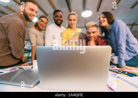 IT designers brainstorming, discussing new ideas on laptop Stock Photo