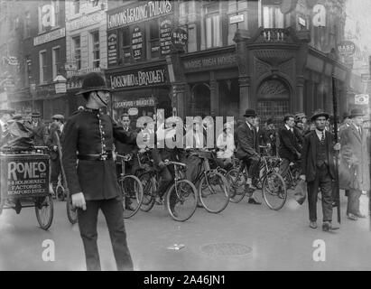 4th May 1926. High Holborn, London, England. A Policeman directs traffic, cyclists, and pedestrians, as the General Strike in the United Kingdom begins. Soon, the streets would see British Army tanks and armoured cars, as troops helped to m agnation order keep basic services running. Stock Photo