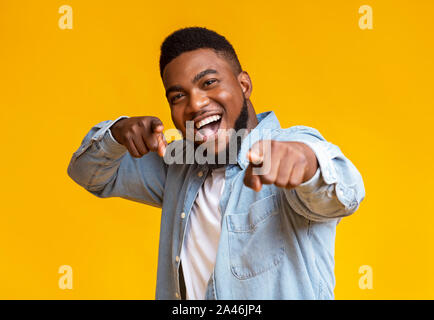 Cheerful african american man pointing fingers at camera Stock Photo