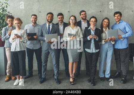 Successful business team. Motivated colleagues smiling to camera Stock Photo