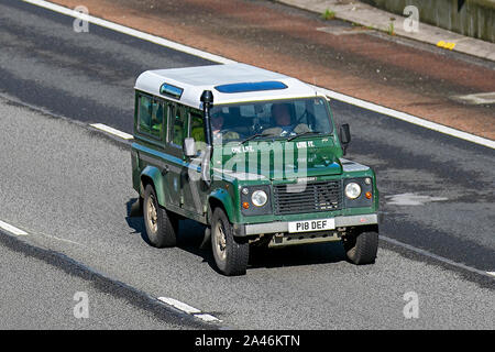 1997 90s nineties green Land Rover 110 Defender County Swtdi; with snorkel exhaust, UK Vehicular traffic, transport, modern, saloon cars, south-bound on the 3 lane M6 motorway highway. Stock Photo