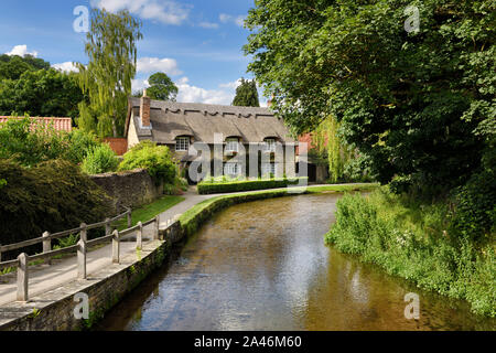 Beck Isle museum thatched roof cottage on the Thornton Beck in Thornton Dale North Yorkshire England Stock Photo