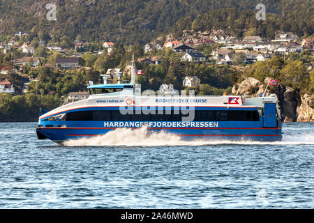 Local high speed passenger catamaran Rygerfonn outbound from port of Bergen, Norway. Passing Askøy island. Stock Photo
