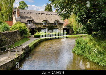 Beck Isle museum thatched roof cottage on the Thornton Beck stream in Thornton-le-Dale North Yorkshire England Stock Photo