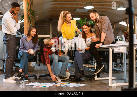 Teamwork. Creative colleagues discussing interior designs with palettes Stock Photo