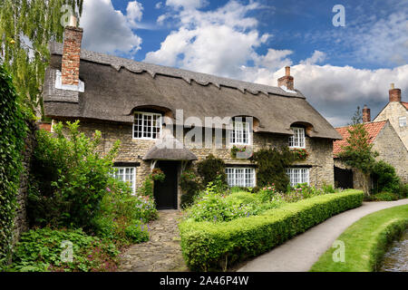 Flower garden at Beck Isle museum thatched roof cottage in Thornton-le-Dale North Yorkshire England Stock Photo