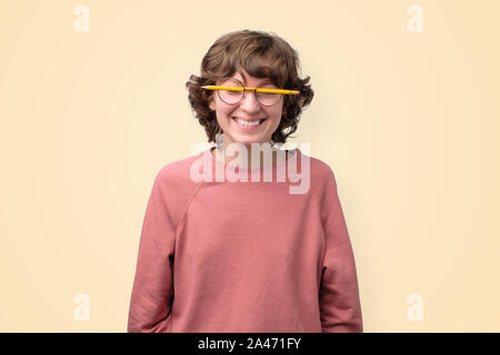 Young funny woman in glasses without lenses is tired to study. Stock Photo