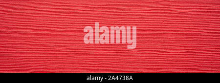 Japanese red linen washi paper with an embossed linear groove texture, panoramic banner Stock Photo