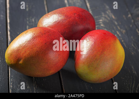 Mango fresh fruit on black wooden table. Stock Photo