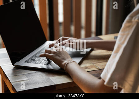 Woman's hands typing on laptop keyboard. Study and work online, freelance. Self employed or freelance woman, girl working with her laptop sitting at Stock Photo