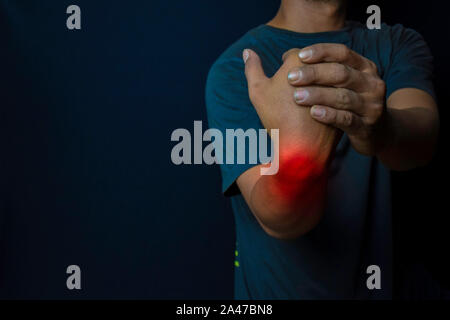 Young man suffering pain weakness and tingling in wrist. Medical or Healthcare concept Stock Photo