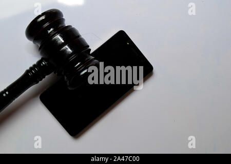 Black smartphone and gavel isolated on white background. Justice and Law Concept Stock Photo