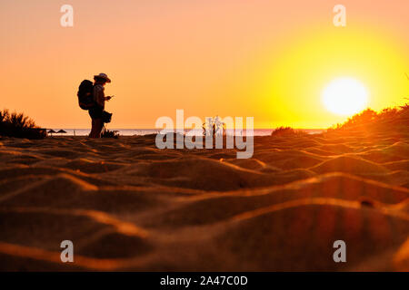 Explorer in Piscinas desert during twilight, Arbus, Sardinia, Italy Stock Photo