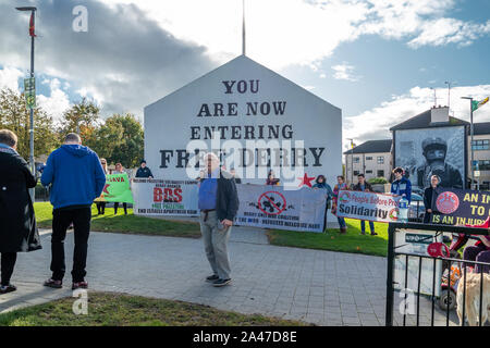 DERRY, LONDONDERRY / NORTHERN IRELAND - OCTOBER 12 2019: People demonstrate against war in front of the Free Derry Monument. Stock Photo