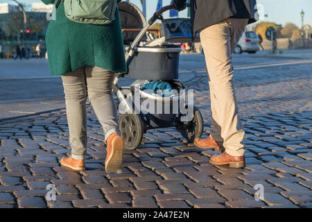 couple ist walking with stroller Stock Photo