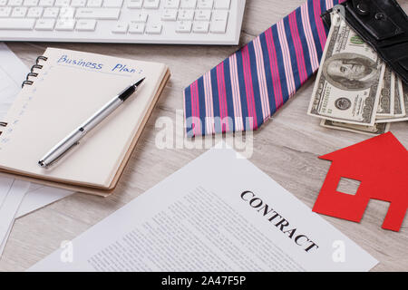 Tie, money and paper house. Stock Photo