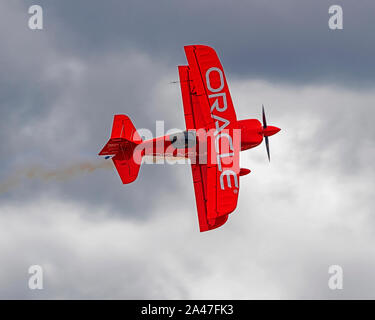 Sean Tucker, Oracle Challenger pilot, cuts a ribbon during one of his ...