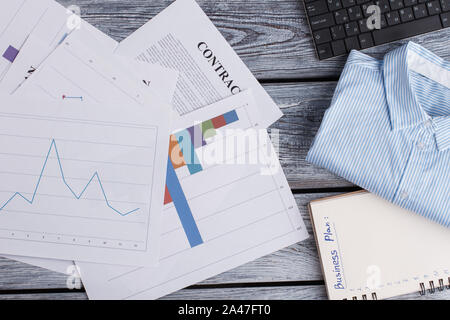 Papers and office items on wooden background. Stock Photo