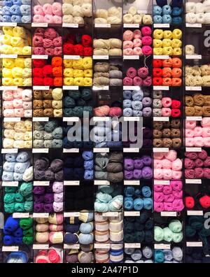 The shelves of a haberdashery store full of colourful wool and yarn Stock Photo