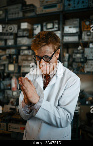 Crazy male scientist conducts a test in laboratory Stock Photo