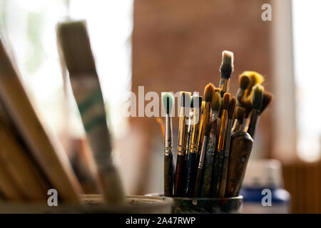 Group of various paintbrushes for professional painting on workplace of artist Stock Photo