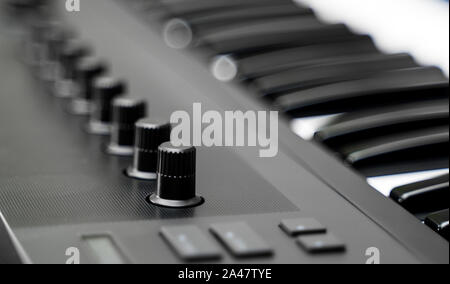 Professional midi keyboard synthesizer with knobs and controllers. Stock Photo