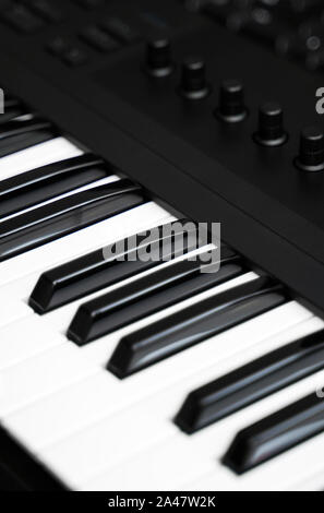 Professional midi keyboard synthesizer with knobs and controllers. Stock Photo