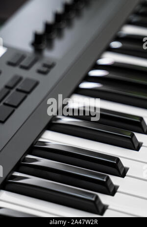 Professional midi keyboard synthesizer with knobs and controllers. Stock Photo