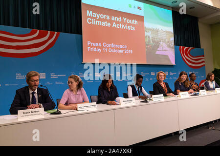 COPENHAGEN, DENMARK – OCTOBER 11, 2019: Mayors and  youth activist holds a joint press conference at the C40 World Mayors.  During the press conference young activist explained what they expect of the grown-up politicians. More than 90 mayors of some of the world’s largest and most influential cities representing some 700 million people meet in Copenhagen from October 9-12 for the C40 World Mayors Summit. The purpose with the summit in Copenhagen is to build a global coalition of leading cities, businesses and citizens that rallies around radical and ambitious climate action. Stock Photo