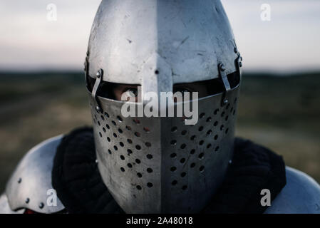 Medieval knight in armor and helmet closeup view Stock Photo