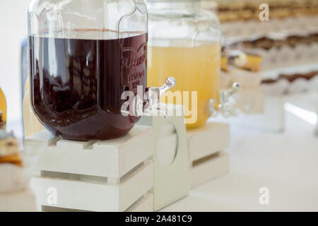 Glass jars of lemonade on wedding candy bar. Catering. Drinks on wedding party. Stock Photo