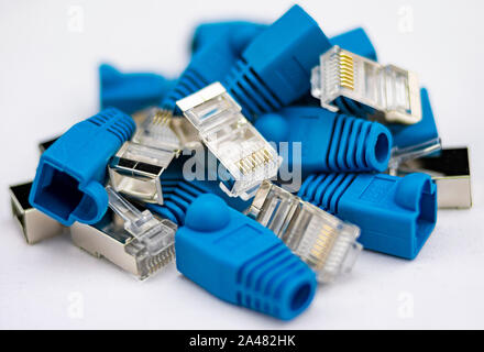 Parts of an RJ45 connector or network cable with gold pins and blue shield with metal insulator Stock Photo