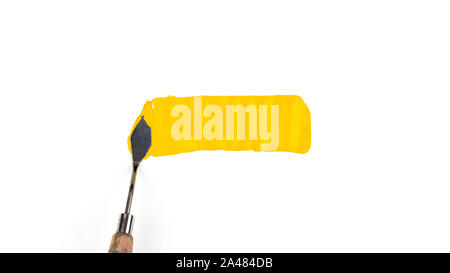 a painting palette knife isolated on a white background painting a yellow with copy space. Stock Photo