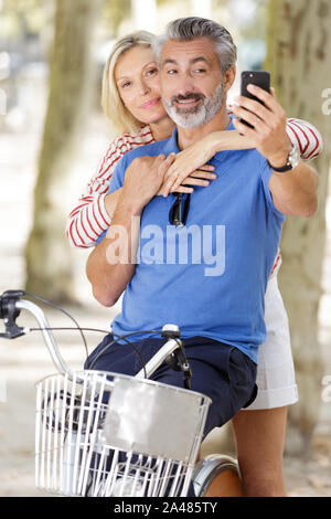 couple on bikes checking the cellphone Stock Photo